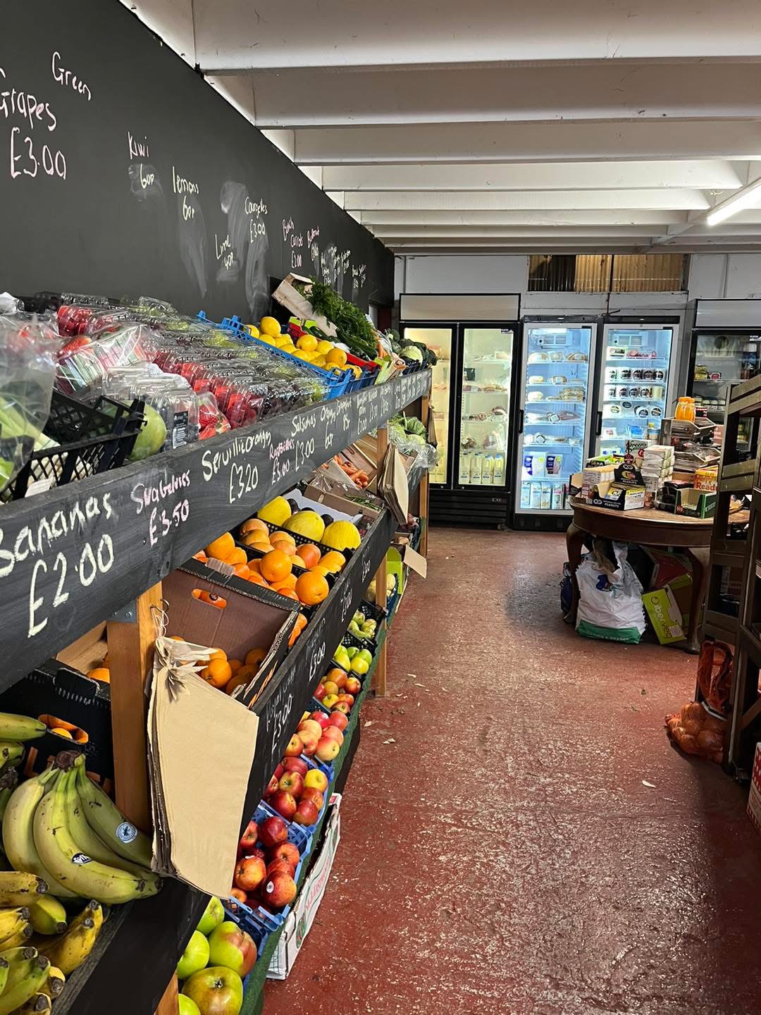 Inside Dauntsey Farm Shop with shelves of fresh fruit and vegetables